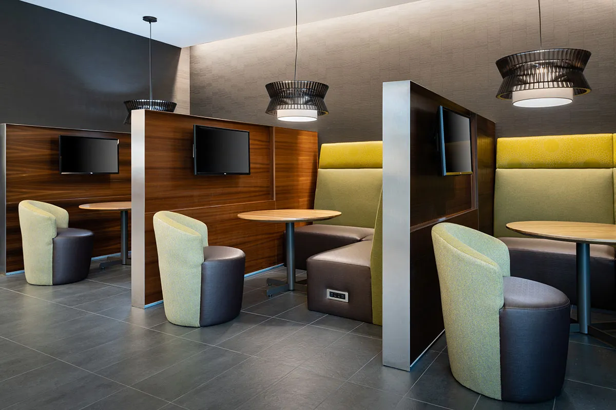 individual seating boots with TV divided by wall between