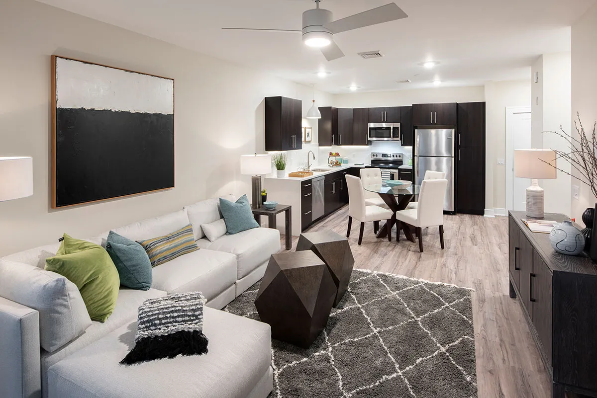 apartment with kitchen, tables and living room with couch