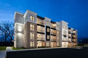 4 story apartment building lit up at night