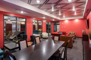 Vicina Apartment common area with red wells and seating