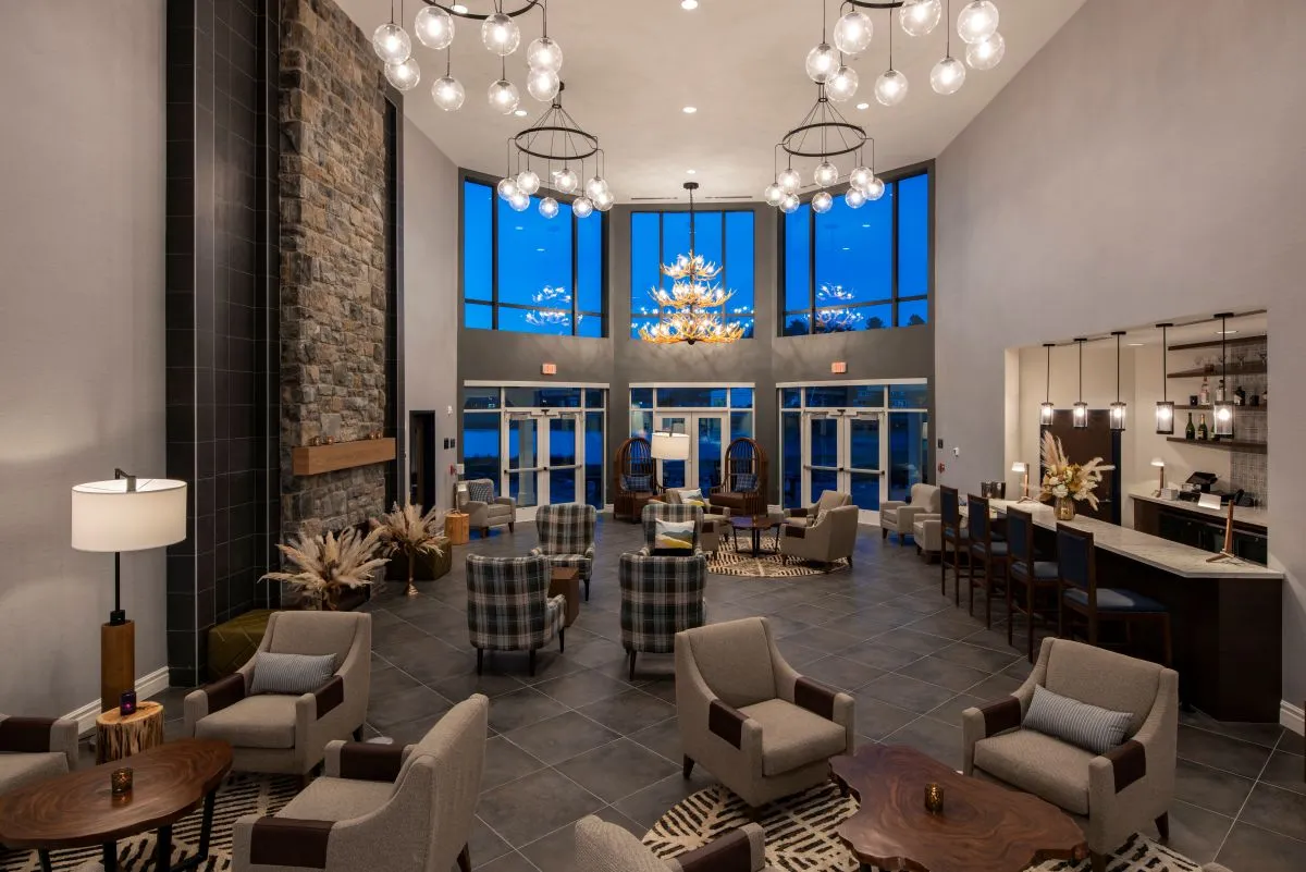 Saranac Lake Resort common area seating with high ceilings and large chandeliers