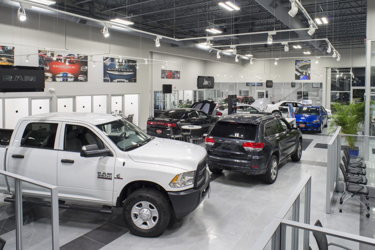 car dealership lobby with several parked cars inside
